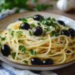 Pasta with black olives served rustic Mediterranean-style