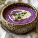 purple potato soup in rustic bowl